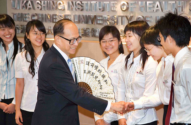 Dr. LI Ka Shing received a paper fan with an inscription "Knowledge reshapes destiny, scientific research constructs people's livelihood" from a group of medical students of CUHK.
